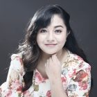 Woman with dark hair posing for a headshot